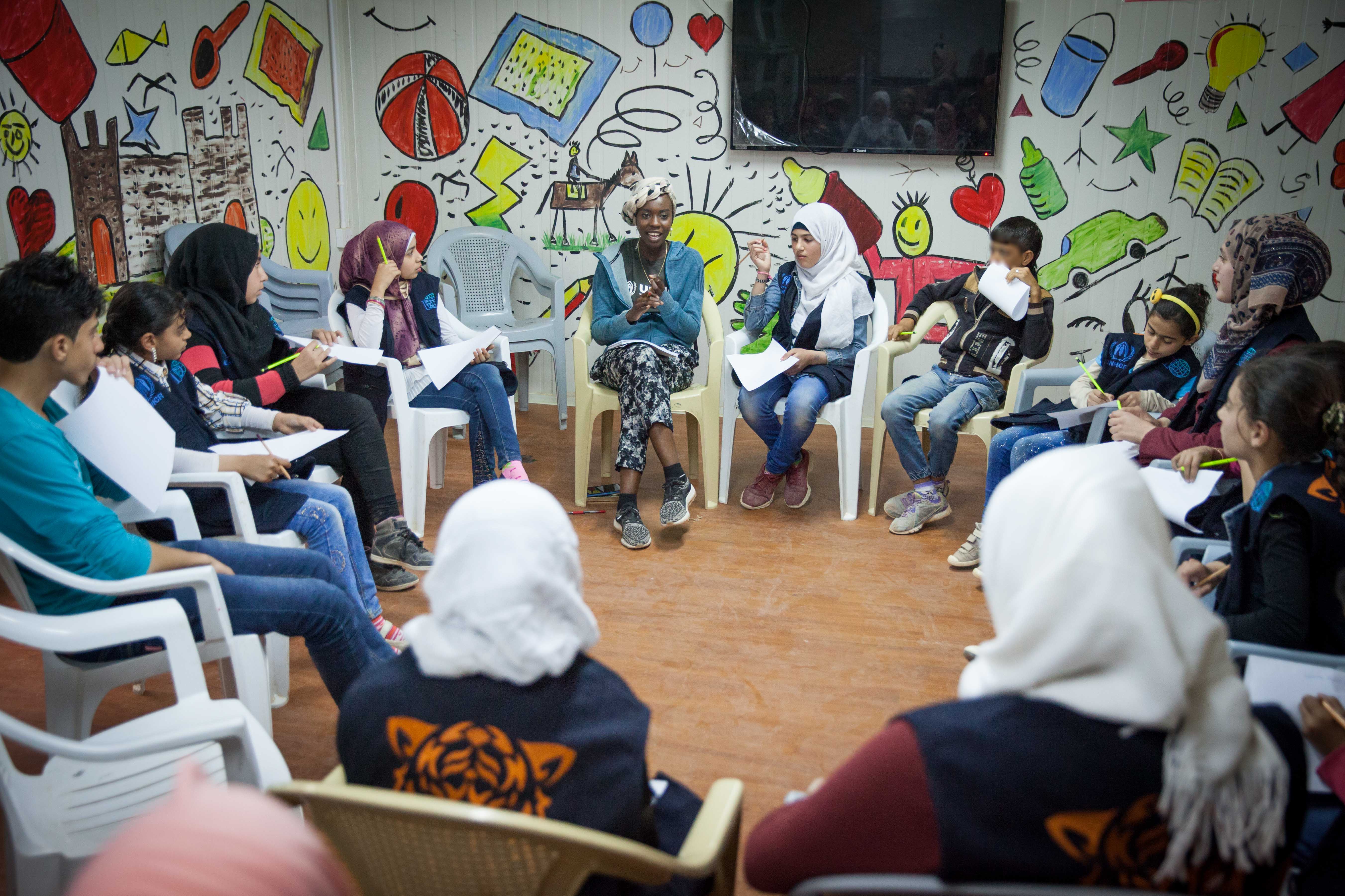 UNHCR High Profile Supporter Emi Mahmoud conducts a poetry workshop with girls and boys at the community center in Zaatari camp, Jordan. ; UNHCR High Profile Supporter Emi Mahmoud visists Syrian refugees in Jordan